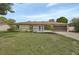 Charming ranch-style home featuring a well-manicured lawn and a welcoming front entrance at 1382 Coronet Dr, Deltona, FL 32725