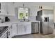 A modern kitchen featuring a stainless steel dishwasher and plenty of counter space at 1382 Coronet Dr, Deltona, FL 32725