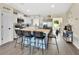 A modern kitchen with a breakfast bar, stainless steel appliances, and white cabinetry at 1382 Coronet Dr, Deltona, FL 32725