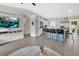 A modern and spacious living room with a view into the kitchen and bar seating at 1382 Coronet Dr, Deltona, FL 32725