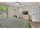Main bedroom with ceiling fan, natural light, and a dresser with a modern design at 1382 Coronet Dr, Deltona, FL 32725