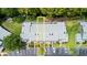 An aerial view of condo building, parking lot, and wooded area with possible waterway at 140 Limewood Pl # C, Ormond Beach, FL 32174