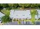 An aerial view of condo building, parking lot, and wooded area with possible waterway at 140 Limewood Pl # C, Ormond Beach, FL 32174