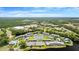 Beautiful community showcasing lush greenery, a pool, tennis courts, and serene lake views at 140 Limewood Pl # C, Ormond Beach, FL 32174