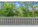 Backyard view of trees and shrubs, with a gray wooden fence in the foreground at 140 Limewood Pl # C, Ormond Beach, FL 32174