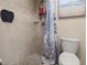 Bathroom with a tiled shower and a shower curtain at 140 Limewood Pl # C, Ormond Beach, FL 32174