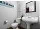 Charming half bath featuring beach decor and pedestal sink with classic fixtures at 140 Limewood Pl # C, Ormond Beach, FL 32174