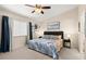 Bedroom with a ceiling fan, queen bed, and coastal inspired decor at 140 Limewood Pl # C, Ormond Beach, FL 32174
