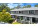 Gray exterior of a multi-Gathering residence with wood and siding details, complimented by some shrubbery at 140 Limewood Pl # C, Ormond Beach, FL 32174