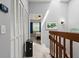 Hallway with a staircase and carpet, leading to a bedroom with ample natural light and closet space at 140 Limewood Pl # C, Ormond Beach, FL 32174