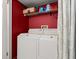 Laundry room with white washer and dryer and storage space on shelf above at 140 Limewood Pl # C, Ormond Beach, FL 32174