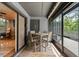 Screened in patio with tile flooring and dining table, connected to outdoor deck at 140 Limewood Pl # C, Ormond Beach, FL 32174