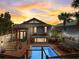 Expansive backyard with a sparkling pool, dining area, and lush landscaping, ideal for entertaining at 1421 N Atlantic Ave, New Smyrna Beach, FL 32169
