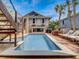 Stunning backyard with a refreshing pool, comfortable lounge chairs, and an outdoor dining space at 1421 N Atlantic Ave, New Smyrna Beach, FL 32169