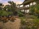 Charming backyard with a fire pit and Adirondack chairs, set against a backdrop of native landscaping at 1421 N Atlantic Ave, New Smyrna Beach, FL 32169