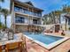 Spacious backyard with a private pool, outdoor dining area, and comfortable seating perfect for relaxation at 1421 N Atlantic Ave, New Smyrna Beach, FL 32169
