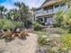 Backyard with fire pit, chairs, and lush landscaping, offering a perfect outdoor retreat at 1421 N Atlantic Ave, New Smyrna Beach, FL 32169