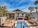 Breathtaking backyard oasis featuring a pool, outdoor dining area, and meticulously maintained landscaping at 1421 N Atlantic Ave, New Smyrna Beach, FL 32169