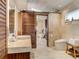 Contemporary bathroom with a vessel sink, soaking tub, and a sliding barn door at 1421 N Atlantic Ave, New Smyrna Beach, FL 32169