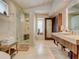 Bright bathroom with a glass walk-in shower, single vanity, and a travertine tile floor at 1421 N Atlantic Ave, New Smyrna Beach, FL 32169