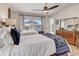 Sunlit bedroom featuring two beds, a wooden dresser, and a balcony entrance at 1421 N Atlantic Ave, New Smyrna Beach, FL 32169