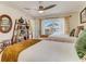 Inviting bedroom with two twin beds, balcony access, and a unique bookshelf decor at 1421 N Atlantic Ave, New Smyrna Beach, FL 32169