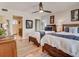 Cozy bedroom featuring two twin beds with wooden frames, terracotta tile flooring, and an attached bathroom at 1421 N Atlantic Ave, New Smyrna Beach, FL 32169