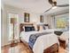 Bright bedroom showcasing two twin beds with stylish blue patterned throws and a window view at 1421 N Atlantic Ave, New Smyrna Beach, FL 32169