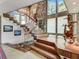 Bright, open foyer with natural light, wood trim, unique decor, and stairs with glass panels at 1421 N Atlantic Ave, New Smyrna Beach, FL 32169