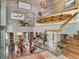 Bright foyer with decor, views of living space, wood trim, and staircase with glass railing at 1421 N Atlantic Ave, New Smyrna Beach, FL 32169