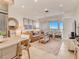 Airy living room featuring tile floors, leather sofa, and doors leading to a balcony with scenic views at 1421 N Atlantic Ave, New Smyrna Beach, FL 32169