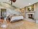 The spacious bedroom features a fireplace and bright light through large windows at 1421 N Atlantic Ave, New Smyrna Beach, FL 32169