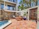 Charming outdoor patio featuring stone accents, an outdoor seating area, and mature landscaping at 1421 N Atlantic Ave, New Smyrna Beach, FL 32169