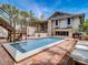 Inviting backyard with a sparkling in-ground pool, brick patio, and a comfortable outdoor seating area at 1421 N Atlantic Ave, New Smyrna Beach, FL 32169