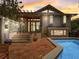 Beautiful pool area with stone accents, a tiled patio, a pergola, and lush landscaping at 1421 N Atlantic Ave, New Smyrna Beach, FL 32169