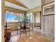 Bright sitting area offers ocean views from expansive windows, with wood floors and casual seating at 1421 N Atlantic Ave, New Smyrna Beach, FL 32169