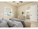 Serene bedroom featuring modern decor, neutral tones, and a peek into the bathroom at 150 Portofino Blvd, New Smyrna Beach, FL 32168