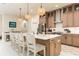 Bright kitchen with a large island, stainless steel appliances, stylish cabinets, and a pantry door at 150 Portofino Blvd, New Smyrna Beach, FL 32168