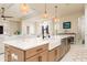 Kitchen island with white countertops, a farmhouse sink, stainless steel appliances, and wicker pendant lighting at 150 Portofino Blvd, New Smyrna Beach, FL 32168