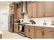 Well-lit kitchen features stainless steel appliances, white countertops, a pantry door, and stylish cabinetry at 150 Portofino Blvd, New Smyrna Beach, FL 32168