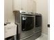 Well-equipped laundry room with a utility sink and modern, front-load Maytag washer and dryer at 150 Portofino Blvd, New Smyrna Beach, FL 32168