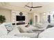 Bright living room features a fireplace, large sectional sofa, recessed lighting, and natural light at 150 Portofino Blvd, New Smyrna Beach, FL 32168