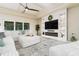 Spacious living room features a stylish fireplace with shelving and large sectional sofa seating at 150 Portofino Blvd, New Smyrna Beach, FL 32168