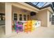 Outdoor bar with colorful seating, a built-in beverage cooler, and a covered patio at 150 Portofino Blvd, New Smyrna Beach, FL 32168