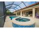 Outdoor pool and spa with screened-in patio for year-round enjoyment and privacy at 150 Portofino Blvd, New Smyrna Beach, FL 32168