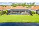 Back of the house with screened lanai and pool, overlooking the lake at 150 Portofino Blvd, New Smyrna Beach, FL 32168