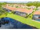 A view of the back of the house showing the screened-in lanai and pool overlooking the lake at 150 Portofino Blvd, New Smyrna Beach, FL 32168
