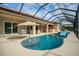 Beautiful swimming pool with a screened enclosure, water feature, and a relaxing outdoor space at 150 Portofino Blvd, New Smyrna Beach, FL 32168