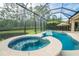 Swimming pool with a screened enclosure, spa, and beautiful views of the natural surroundings at 150 Portofino Blvd, New Smyrna Beach, FL 32168