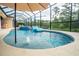 Swimming pool with a screened enclosure, spa, and serene views of the lush landscaping at 150 Portofino Blvd, New Smyrna Beach, FL 32168